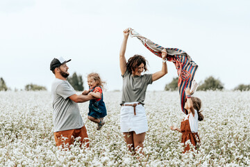 Happy family walking in field, playing and enjoying summer day.  Livestyle walking concept
