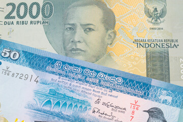 A macro image of a grey two thousand Indonesian rupiah bank note paired up with a blue and white...