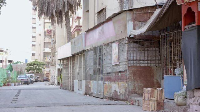 Rusty shop shutters are down outside an sealed apartment building in Karachi because many Covid cases during lockdown announced by the government