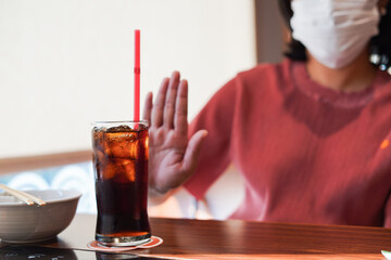 Close up slim woman hand push out say no avoid and reject her favorite cola soft drink high sweet...