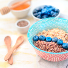 High protein healthy breakfast, buckwheat porridge with blueberries and honey