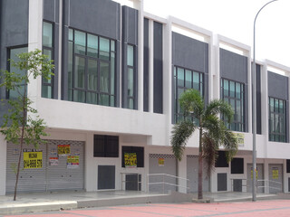 SEREMBAN, MALAYSIA - JULY 04, 2019: Multy-story terrace shop lots facade at the new commercial area. The shop lot facade designed with modern design to attract buyer and customer.   © Aisyaqilumar
