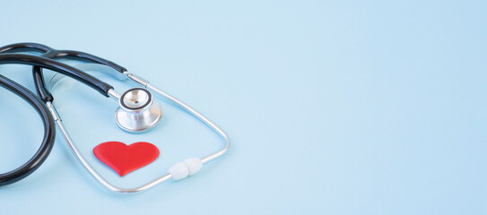 Stethoscope and red heart on a blue background. Greeting background. National doctor's day. Happy nurse 's day. Health day. Top view, a copy of the space.