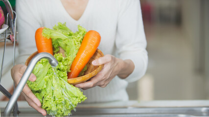 woman holding vegetables