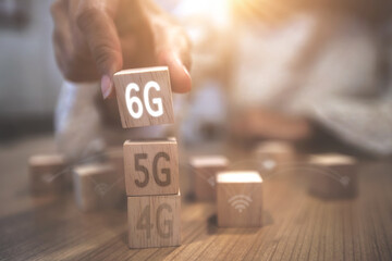 The hand is picking up the 6G dice in the social media network connection concept.
