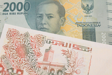 A macro image of a grey two thousand Indonesian rupiah bank note paired up with a beige 200 Algerian dinar bank note.  Shot close up in macro.