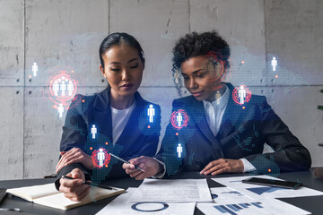 Two businesswomen work together in modern office on new project. Double exposure. Concept of success. Planet earth world map.