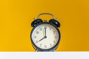 alarm clock displaying 8 hours on yellow background