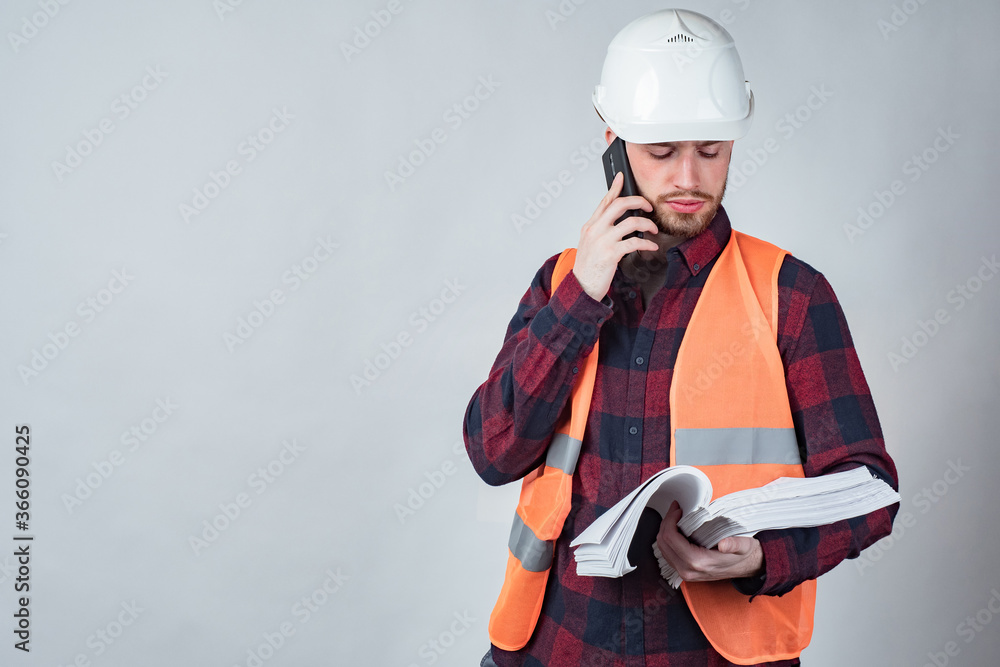 Poster builder with papers in his hands. concept - documents for construction. man in a building uniform. w