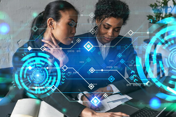Two businesswomen work together in modern office on new project. Double exposure. Concept of success. Tech hologram.