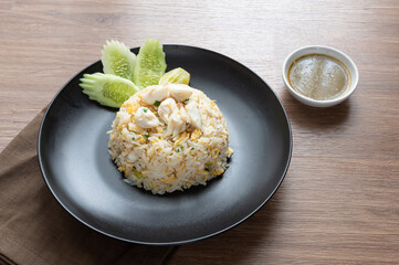 Delicious Fried rice with crab meat, egg, garlic, cucumber, lemon. Thai food called Khao pad poo.