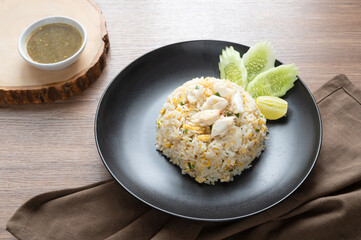 Delicious Fried rice with crab meat, egg, garlic, cucumber, lemon. Thai food called Khao pad poo.
