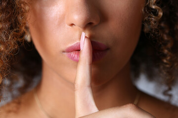 Close up cropped head of beautiful female gesturing to be quit with hands isolated on grey background