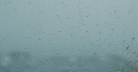 Heavy raining outside, rain on the window glass