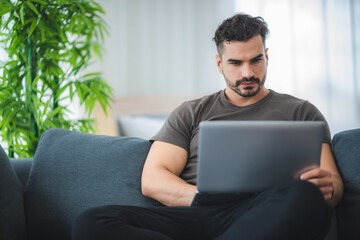 handsome man working from home with laptop, business freelancer concept