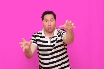 Naklejka premium Caucasian man wearing casual striped t-shirt standing over isolated hot pink background shows various gestures.