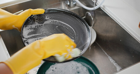 Woman wash dish in kitchen