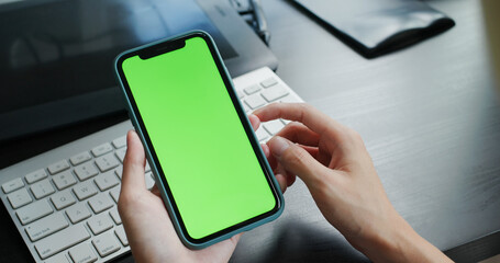 Woman use of cellphone with green screen