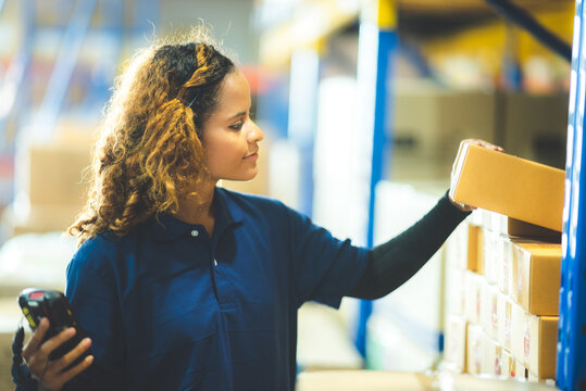 warehouse worker using bar code scanner to scanning box and analyze newly arrived goods for further placement in storage department, Working at warehouse.