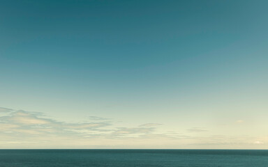 North Sea under blue sky with scattered clouds in summer. Flamborough Head, UK.