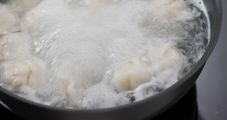 Cooking with meat dumpling in kitchen