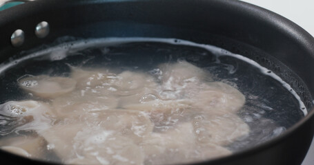 Cooking with meat dumpling in kitchen
