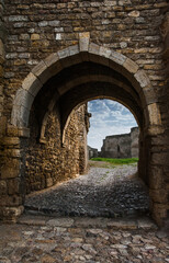 Fototapeta na wymiar Archway in the ancient stone wall