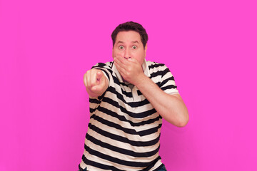 Caucasian man wearing casual striped t-shirt standing over isolated hot pink background shows...