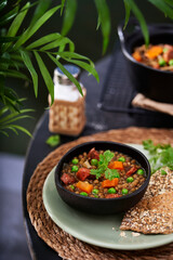 Lentil Chorizo Stew with vegetables on a table. Selective focus, copy space. Mediterranean cuisine.