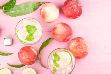 Summer cold alcohol beverage, iced peach Bellini cocktail with mint leaves,