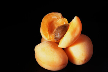 Apricots on a black background