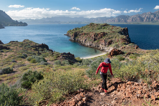One woman hiking on a trail in Del Carmen Island at Loreto Bay