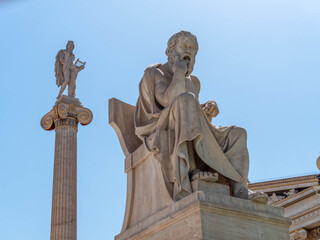 Fototapeta na wymiar Socrates the philosopher and Apollo god of the arts marble statues, Athens Greece