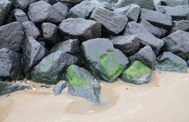 Giant Rocks On The Beach Protecting The Sea Wall.