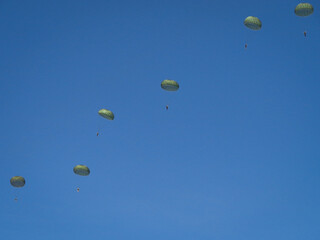 Paratroopers against a blue sky