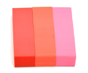 Close-up of three erasers