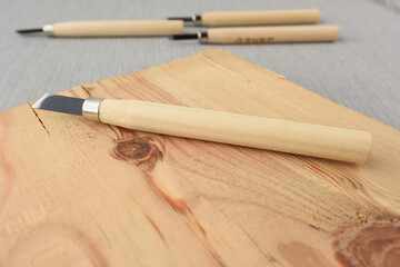 Set of different tools for cutting wood products, with wooden handle and wooden board on grey background. set carpentry tools. profession, carpentry, woodwork and people concept
