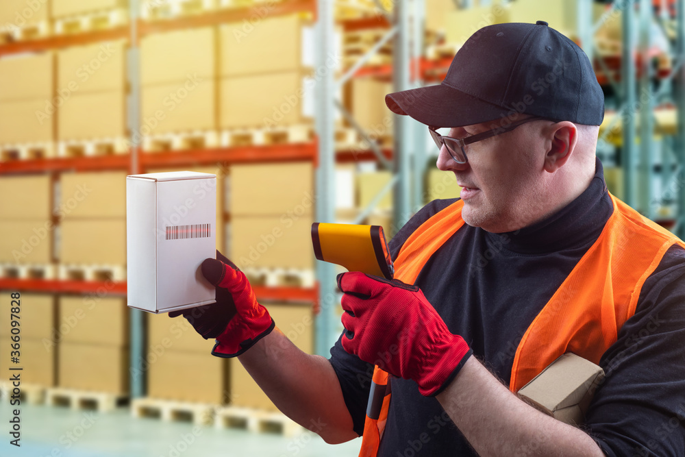 Poster warehousing. warehouse worker on background of shelving with boxes. box with a barcode èí hands of a