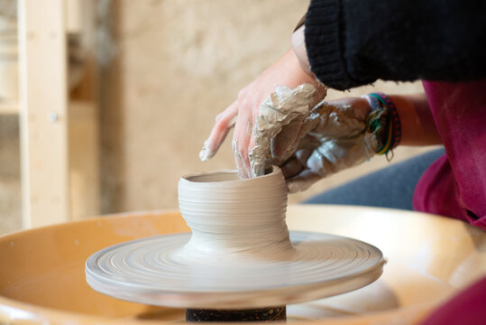 Ceramist artist female working in her atelier with The Pottery Wheel