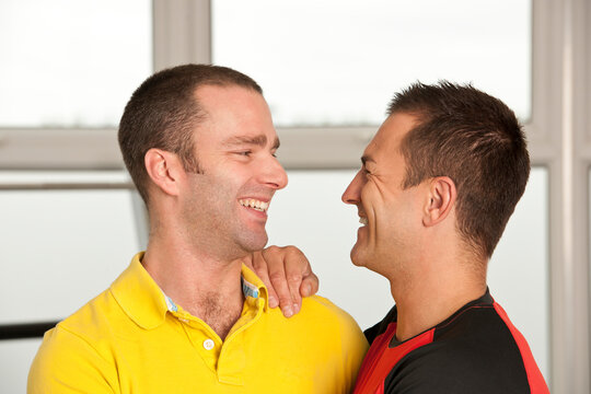 gay couple embracing at gym in the UK