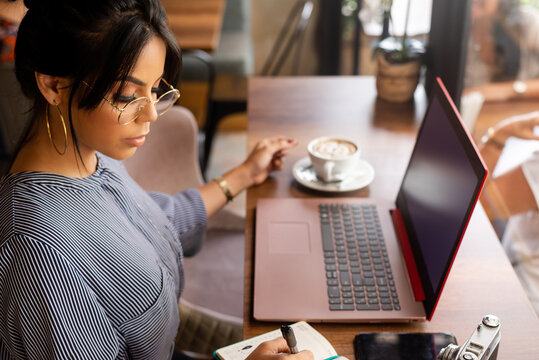 girl having a coffee while working in a cozy environment