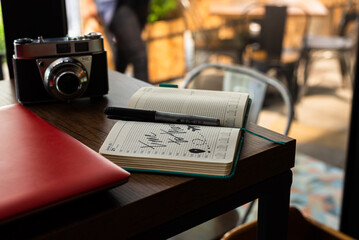 travel time, travel planner next to an old camera and computer, arrivi