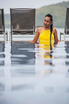 beautiful woman enjoying a relaxing time in the pool of luxury resort
