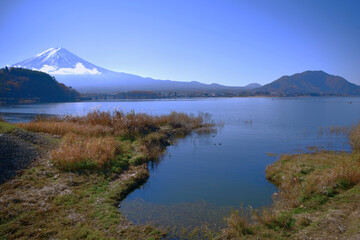 Naklejka na ściany i meble Panoramic view on wonderful mount Fuji and lake in foreground. Tranquil and calm scenery.
