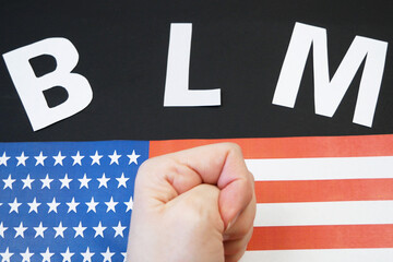 black lives matter concept, letters BLM, american flag
