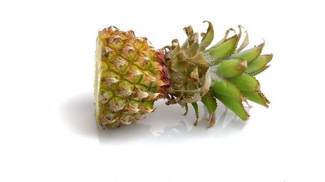 sliced baby pineapple isolated on white