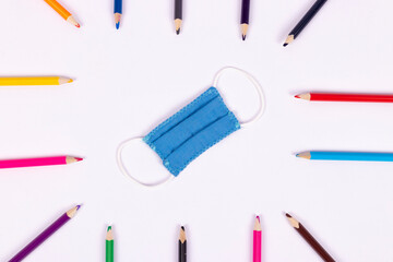 Back to school background with supplies and face mask, copy space.