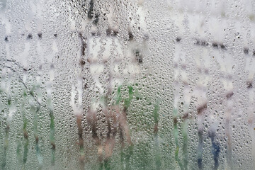 Close-up of raindrops on fogged glass