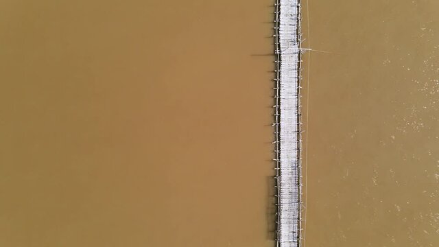 Aerial drone view over the Bamboo bridge of Koh Paen island. Ascending footage from the bridge