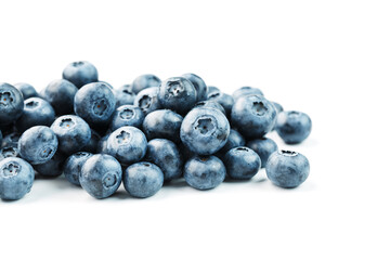 Blueberries are scattered on a white background. Free space, isolate. Studio light.